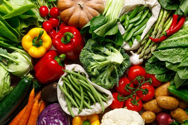 Vegetables background. Various vegetables on kitchen table. Clean eating, healthy food concept, flat lay, top down view